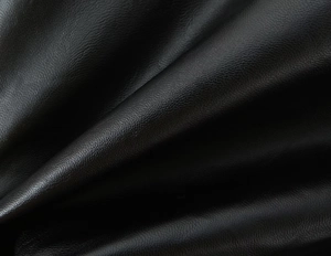 Close-up of premium black PU leather texture with detailed lychee grain pattern