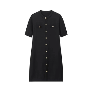 Detail of black short sleeve knit dress showing golden buttons and ribbed edges