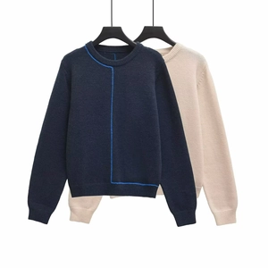 Detail of ribbed crew neck and contrasting trim on knitted long sleeve sweaters