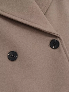 Detail of wool blend short coat showing marble pattern buttons and fine fabric texture