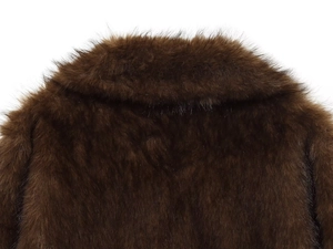 Close-up of dark brown faux fur jacket collar and thick soft texture on the back
