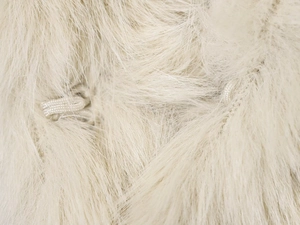 Macro shot of ivory faux fur texture showing soft plush fibers and elastic hook closure