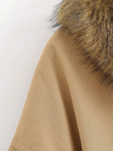 Detail of camel baseball jacket with thick faux fur collar and textured twill fabric