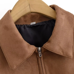 Detailed view of the spread collar and texture of the caramel faux suede jacket