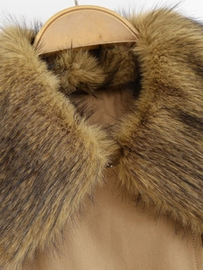 Detail of luxurious brown faux fur collar on winter bomber jacket with soft texture