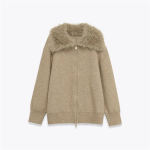 Detail of khaki knit sweater featuring a plush faux fur collar and gold dual zipper