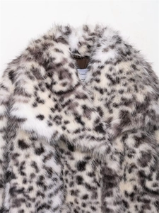 Detailed close-up of leopard print faux fur jacket with wide collar and soft inner lining
