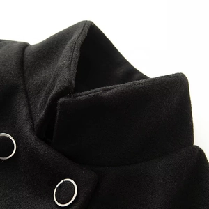 Detail of black wool coat collar featuring textured fabric and decorative silver metal ring