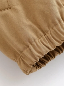 Close-up of khaki jacket elastic cuffs showing fine twill texture and stitching