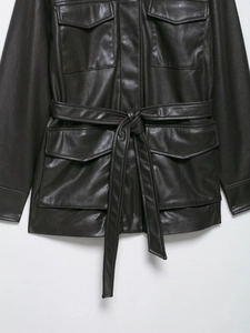 Detail view of deep brown faux leather jacket with four pockets and adjustable waist belt