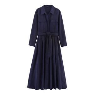 Detail of navy blue shirt dress featuring a classic collar, chest pockets and waist belt