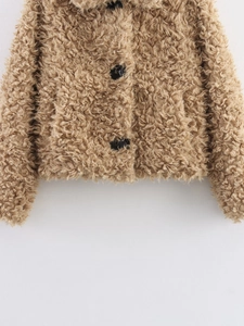 Close-up of light brown teddy fleece jacket with black round buttons and wide lapels