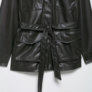 Fashionable PU leather jacket with waist belt and four functional flap pockets for women