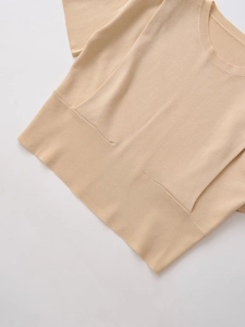 Detail of the crew neck and fine knit texture of this apricot short sleeve top for women