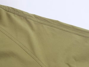Close-up of olive green drawstring jacket featuring durable double-needle stitching detail