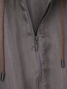 Detail of invisible zipper and brown braided drawstrings on dark grey pilot jacket