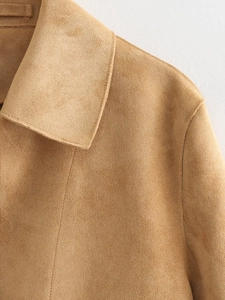 Detailed view of camel suede jacket collar and shoulder with refined stitching lines