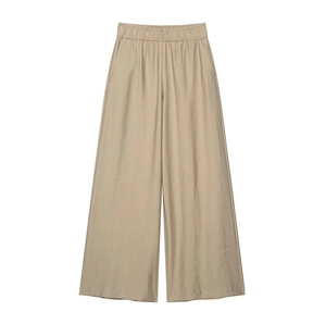Close-up of beige wide-leg trousers showing elastic waist and fine fabric texture