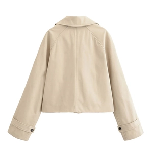Detail view of the back of a beige short trench coat with adjustable buttoned cuffs