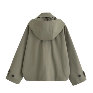Detail view of the back of a pea green hooded cloak jacket with vertical seam and button cuffs