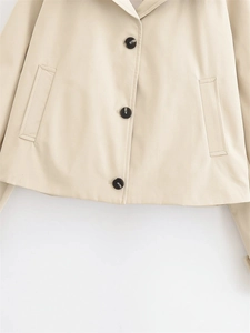 Detailed view of single-breasted short trench coat with premium marble pattern buttons