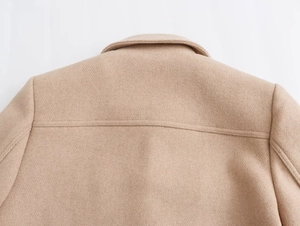Detailed view of the back collar and shoulder stitching of a beige wool coat for women