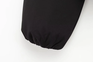 Detail of elastic cuffs on a black puffer jacket with professional stitching on fabric