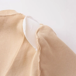 Women's light camel knit top with built-in shoulder pads and fine ribbed texture detail