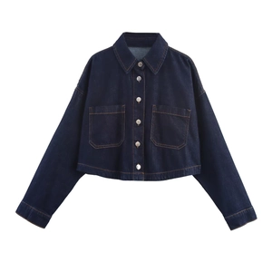 Detail of dark blue denim jacket featuring silver buttons and classic stitching