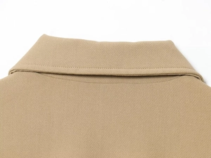 Detailed macro view of khaki jacket lapel collar with precise stitching on twill fabric