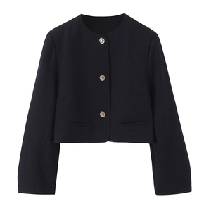 Detailed view of dark short blazer featuring textured fabric and embossed silver buttons