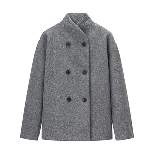 Détail du manteau gris à double boutonnage montrant la texture laine et le col montant