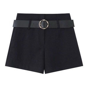 Close-up of black high-waisted shorts featuring a chic gold twisted buckle belt detail