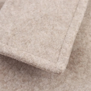 Detailed close-up of beige wool fabric showing high-quality stitching and soft texture