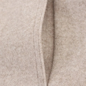 Detail of camel wool blend fabric featuring professional double-stitched pocket seams
