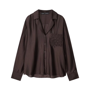 Detailed view of the dark brown shirt pocket featuring intricate matching embroidery