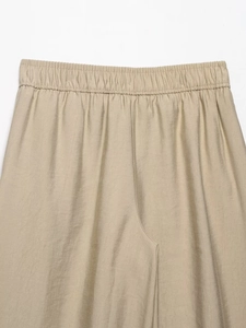 Detail of high-quality elastic waistband on khaki cotton linen wide-leg trousers