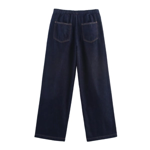 Detail of dark blue wide-leg denim pants with elastic waist and contrast stitching