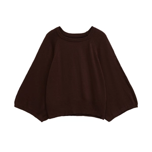 Detail showing high-quality ribbed texture and cuffs on a brown knit sweater