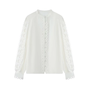Detail of elegant white long sleeve shirt showing delicate lace embroidery and stand collar
