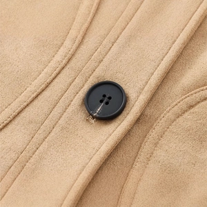 Cropped view of camel faux suede jacket featuring black button and precision stitching