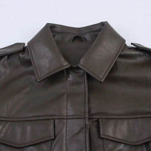 Detailed close-up of dark brown PU leather jacket with shoulder straps and large front pockets