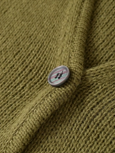 Close-up of olive green knit fabric texture with a striped four-hole button detail