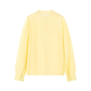 Detail view of yellow shirt lantern sleeves with scalloped lace edges and fabric buttons