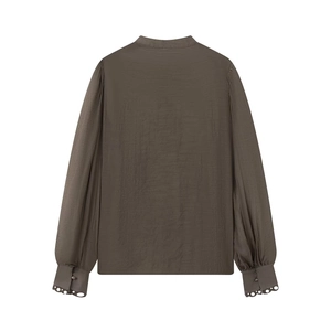 Detail of long sleeve shirt back with lace-trimmed cuffs and textured fabric
