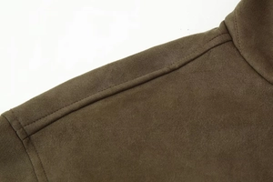 Detailed stitching and texture of an olive green faux suede bomber jacket shoulder
