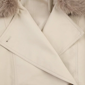 Detailed view of plush faux fur collar and premium twill fabric on women's short trench coat
