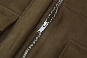 Detail of silver metal zipper on premium brown faux suede pilot jacket fabric