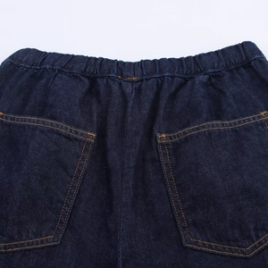 Detail of high-elastic waist and back pockets on dark blue heavy denim jogger pants