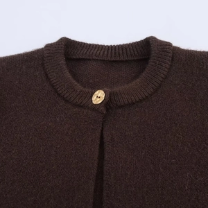 Chic dark brown knit cardigan with fringe hem and elegant golden irregular button